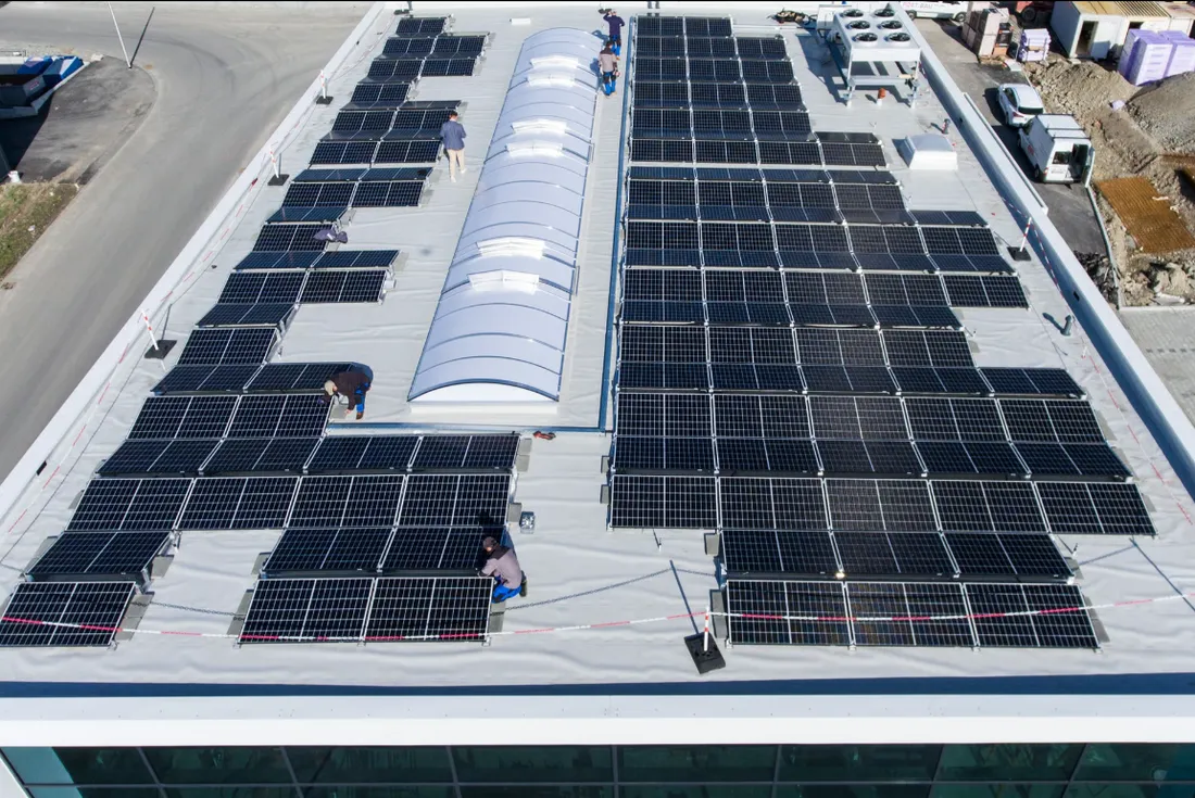 Großflächige PV-Anlage auf einem Gewerbedach während der Montage